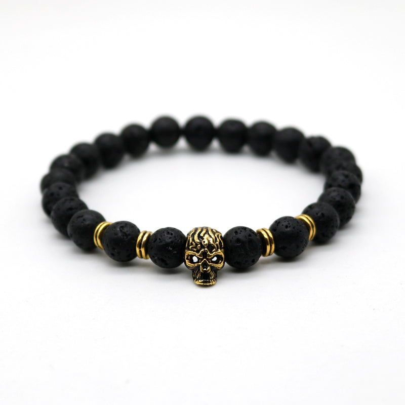 Gold or silver skull bracelet. Black lava stone beads. Nice one.